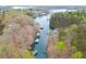 Aerial view of waterfront property, showcasing private boat docks, calm waters, and tree-lined shores at 5995 Lanier Heights Cir, Buford, GA 30518