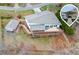 Stunning lakefront home featuring a large deck, boat dock, and a charming guest house, all set amidst a serene natural landscape at 5995 Lanier Heights Cir, Buford, GA 30518
