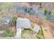 Property featuring a well-maintained home, a detached garage, and a serene view of the surrounding natural landscape at 5995 Lanier Heights Cir, Buford, GA 30518