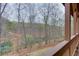 Relax on the large wooden back deck overlooking the wooded surroundings and water at 5995 Lanier Heights Cir, Buford, GA 30518