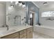 Modern bathroom with double vanity, frameless shower, and soaking tub at 5995 Lanier Heights Cir, Buford, GA 30518