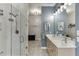 Modern bathroom with double vanity, frameless shower, and laundry room access at 5995 Lanier Heights Cir, Buford, GA 30518