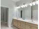 Bathroom with a double sink vanity, large mirror, and tile flooring at 5995 Lanier Heights Cir, Buford, GA 30518