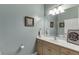 Light filled bathroom featuring a big mirror, vanity, and humorous decor at 5995 Lanier Heights Cir, Buford, GA 30518