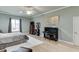 Large bedroom featuring a piano, light hardwood floors, and an area rug at 5995 Lanier Heights Cir, Buford, GA 30518