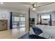Spacious bedroom with sitting area, ceiling fan, and access to a screened-in porch at 5995 Lanier Heights Cir, Buford, GA 30518