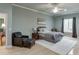 Bedroom with a plush area rug, chair with ottoman, and bright natural light at 5995 Lanier Heights Cir, Buford, GA 30518