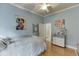 Bedroom featuring light blue walls, artwork, and an ensuite bathroom at 5995 Lanier Heights Cir, Buford, GA 30518