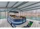 A covered boat dock with a pontoon boat sits on the still lake at 5995 Lanier Heights Cir, Buford, GA 30518