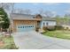 Attractive home with a brick and siding exterior, featuring a large driveway and beautifully landscaped front yard at 5995 Lanier Heights Cir, Buford, GA 30518