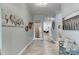 Inviting tiled hallway with modern decor, leading to rooms filled with natural light and stylish furnishings at 5995 Lanier Heights Cir, Buford, GA 30518