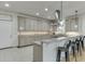 Spacious kitchen featuring gray cabinets, stainless steel appliances, and a breakfast bar at 5995 Lanier Heights Cir, Buford, GA 30518