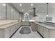 Well-appointed kitchen with sleek countertops, custom cabinets, and stainless steel hood at 5995 Lanier Heights Cir, Buford, GA 30518