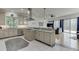 Open kitchen overlooking the living area, featuring a gas cooktop and breakfast bar at 5995 Lanier Heights Cir, Buford, GA 30518