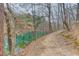 Scenic lake view with trees and a walking trail along the shoreline, promoting nature and recreation at 5995 Lanier Heights Cir, Buford, GA 30518