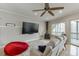 Cozy living room with a fireplace, large TV, and comfortable seating with natural light at 5995 Lanier Heights Cir, Buford, GA 30518