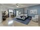 Spacious primary bedroom with a four-poster bed, sitting area, and ample natural light at 5995 Lanier Heights Cir, Buford, GA 30518