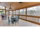 Screened-in porch with tile floor, dining table and outdoor view at 5995 Lanier Heights Cir, Buford, GA 30518