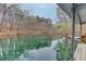 A tranquil view of the cove, with trees reflecting on the water at 5995 Lanier Heights Cir, Buford, GA 30518