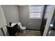 A small bathroom featuring a vanity with a modern faucet, toilet, and vinyl flooring at 2172 Nancy Way, Loganville, GA 30052