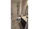 A compact bathroom featuring a shower stall with shelves, toilet, and a modern vanity at 2172 Nancy Way, Loganville, GA 30052