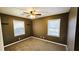 Dimly lit bedroom with carpet and natural light from two windows at 2172 Nancy Way, Loganville, GA 30052