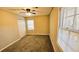 Cozy bedroom with carpet, ceiling fan, and natural light from two windows at 2172 Nancy Way, Loganville, GA 30052