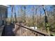 Inviting outdoor wooden deck offers a serene view of the surrounding trees and natural landscape at 2172 Nancy Way, Loganville, GA 30052