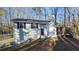 Inviting single-Gathering home featuring a neutral exterior, classic black shutters, and a cozy wooden deck at 2172 Nancy Way, Loganville, GA 30052