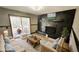 Staged room features a stone fireplace, hardwood floors, deck access, and comfortable seating at 2172 Nancy Way, Loganville, GA 30052