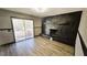 Cozy room with hardwood floors, a unique stone fireplace, and sliding door access to the outdoor deck at 2172 Nancy Way, Loganville, GA 30052