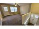 Bright living room with neutral carpet, a ceiling fan, and access to a back deck through a glass door at 2172 Nancy Way, Loganville, GA 30052
