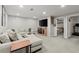 Finished basement with a cozy sectional sofa, entertainment center, and bedroom access at 3171 Jessica Dr, Douglasville, GA 30135