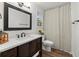 Bathroom with a modern vanity, a well-lit mirror, and a shower with a curtain at 3171 Jessica Dr, Douglasville, GA 30135