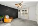 Bedroom with a dark accent wall, comfortable armchair, and a bright window view at 3171 Jessica Dr, Douglasville, GA 30135
