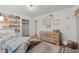 Bedroom featuring a stylish seating area, decorative bookshelves, and a neutral-toned dresser at 3171 Jessica Dr, Douglasville, GA 30135