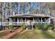 Charming home with a dark exterior, front porch, and well-maintained landscaping at 3171 Jessica Dr, Douglasville, GA 30135