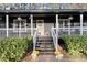 Charming home with a dark exterior, front porch, and well-maintained landscaping at 3171 Jessica Dr, Douglasville, GA 30135
