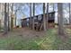 This is a two-story home with black siding, a deck, and a staircase leading to the backyard at 3171 Jessica Dr, Douglasville, GA 30135