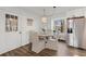 Eat-in kitchen features stainless appliances, wood floors, and a dining table at 3171 Jessica Dr, Douglasville, GA 30135