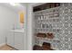 Organized pantry with stylish wallpaper, shelving, and storage baskets at 3171 Jessica Dr, Douglasville, GA 30135
