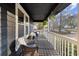 Covered porch with cozy seating and decorative hanging plants, perfect for relaxing outdoors at 3171 Jessica Dr, Douglasville, GA 30135