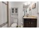 Well-lit bathroom with a vanity, marble countertop, and a shower with a decorative curtain at 3475 Summerlin Pkwy, Lithia Springs, GA 30122