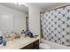 Bathroom featuring a tub with patterned shower curtain, vanity and sink with marble countertop at 3475 Summerlin Pkwy, Lithia Springs, GA 30122