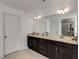 Spacious bathroom featuring double sinks, granite countertops, a large mirror, and a glass enclosed shower at 3475 Summerlin Pkwy, Lithia Springs, GA 30122