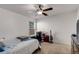 Modest bedroom featuring a ceiling fan, desk, and ample space, perfect for relaxation at 3475 Summerlin Pkwy, Lithia Springs, GA 30122