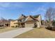 Side view of an attractive two-story house showcasing a long driveway and a well-maintained lawn at 3475 Summerlin Pkwy, Lithia Springs, GA 30122