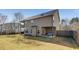 Rear view of the house showcasing a spacious backyard and covered patio seating area at 3475 Summerlin Pkwy, Lithia Springs, GA 30122