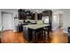 Spacious kitchen features dark cabinetry, granite countertops, stainless steel appliances, and hardwood floors at 3475 Summerlin Pkwy, Lithia Springs, GA 30122