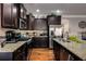 Kitchen with granite countertops, stainless appliances, a breakfast bar, and dark cabinets at 3475 Summerlin Pkwy, Lithia Springs, GA 30122
